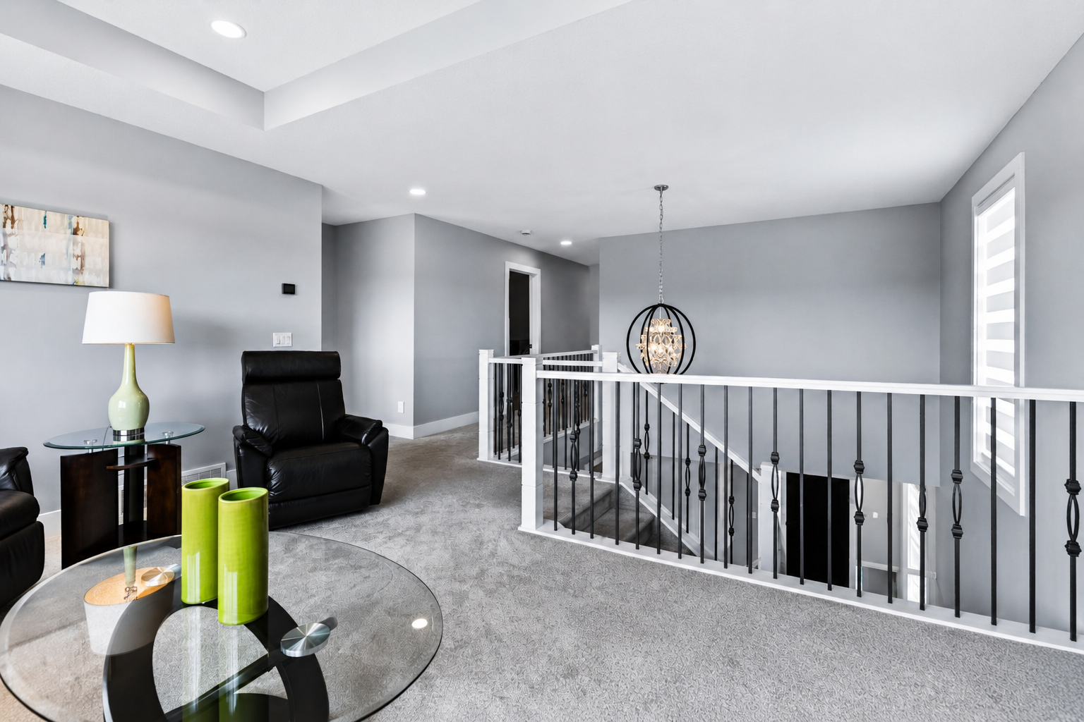 Upper landing with orb chandelier and iron railings
