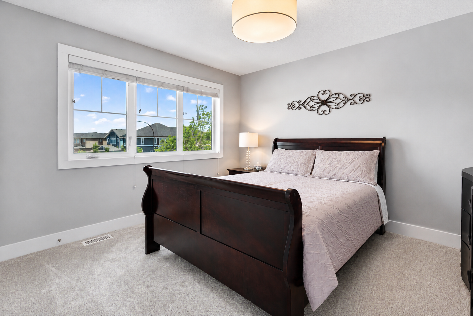 Secondary bedroom with dark sleigh bed