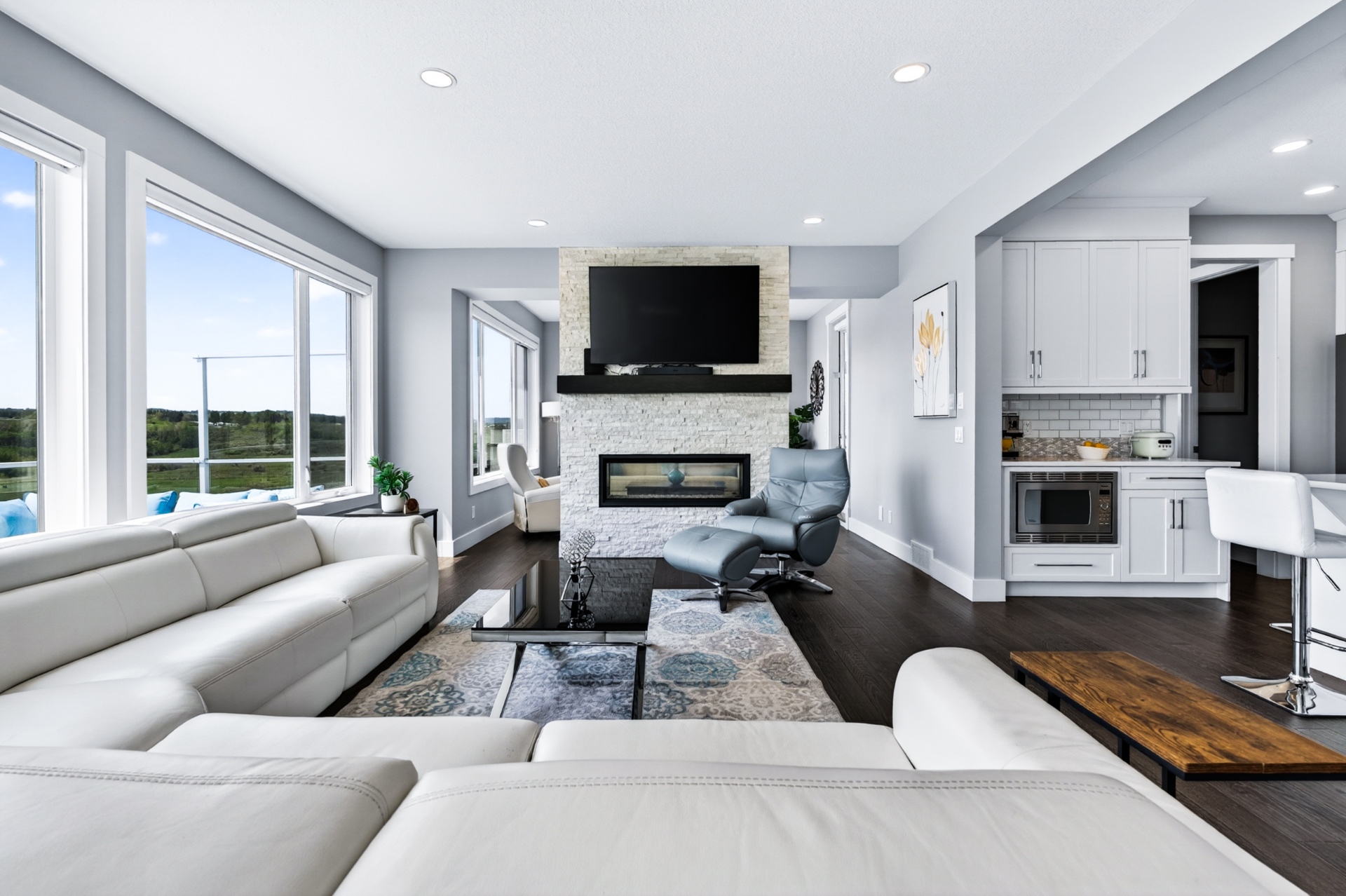 Open concept living room with extended custom windows overlooking the ridge